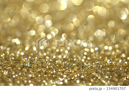 Gold shimmer glitter background with focus and bokeh Gold shimmer glitter background with focus and bokeh 134901707