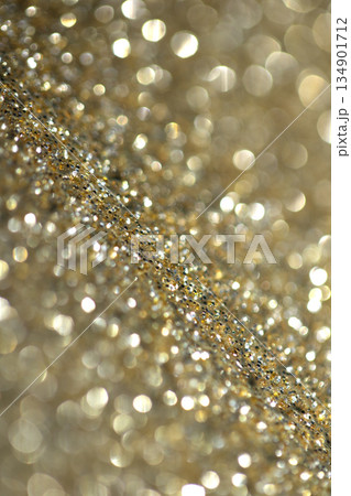 Gold shimmer glitter background with focus and bokeh Gold shimmer glitter background with focus and bokeh 134901712