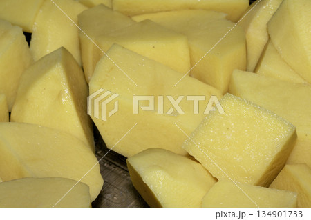 Close up of raw potatoes peeled and chopped ready to be roasted 134901733
