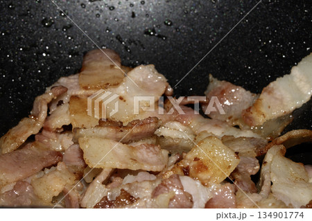 Close up of frying fried bacon pieces ready to be eaten 134901774