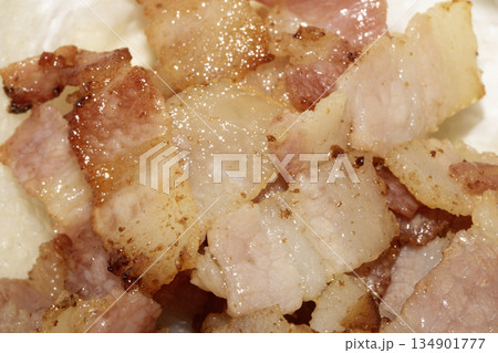 Close up of frying fried bacon pieces ready to be eaten 134901777