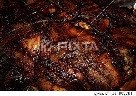 Close up of bacon covered roast chicken cooked in the oven and meat ready to be eaten Close up of bacon covered roast chicken cooked in the oven and meat ready to be eaten 134901791