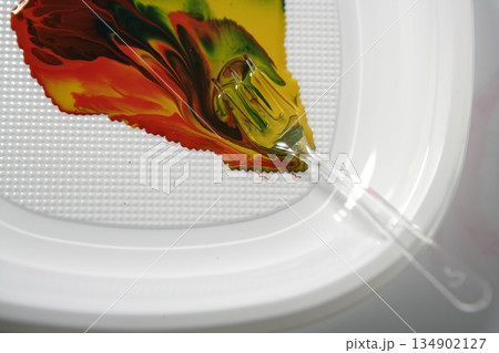 Paint colorful mix with a plastic fork Paint colorful mix with a plastic fork 134902127