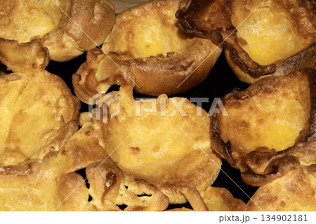 Close up of home made Yorkshire Puddings in roasting tin Close up of home made Yorkshire Puddings in roasting tin 134902181