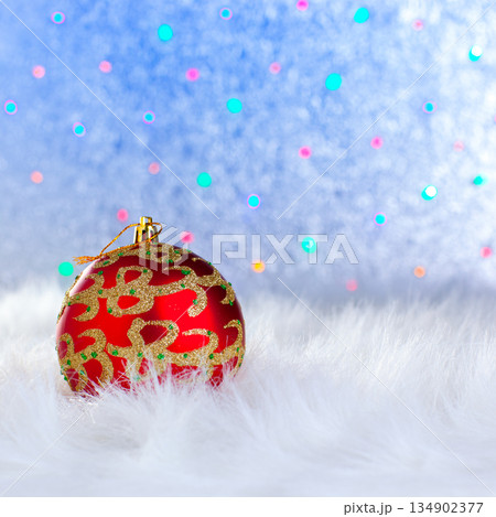 christmas bauble on white fur and lights christmas bauble on white fur and lights 134902377