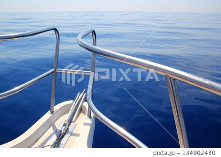 boat sailing blue calm ocean sea bow railing 134902430