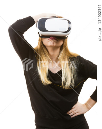 Woman wearing VR goggles Woman wearing VR goggles 134902542