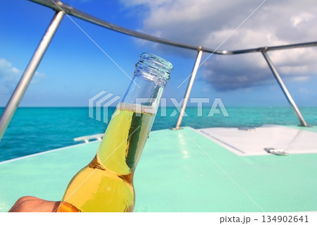 beer on Caribbean boat bow deck turquoise sea beer on Caribbean boat bow deck turquoise sea 134902641