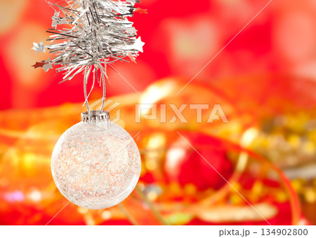 Christmas tinsel snow crystal bauble on red Christmas tinsel snow crystal bauble on red 134902800