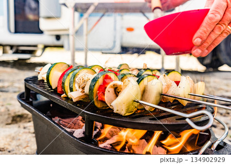 Grilled vegetables on barbecue grill. Rv in the distance 134902929
