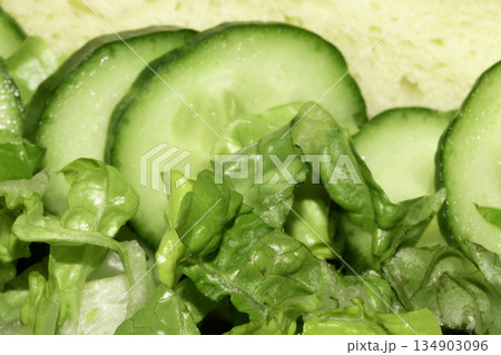 Close up of healthy lettuce and cucumber slices on bread Close up of healthy lettuce and cucumber slices on bread 134903096