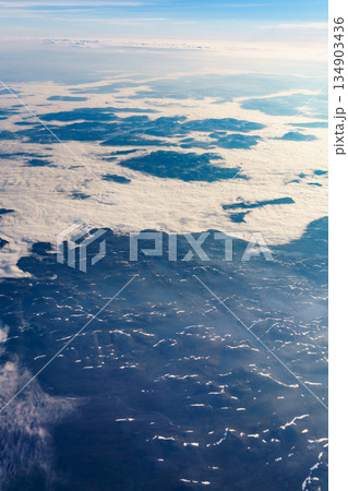 View from airplane to clouds and land View from airplane to clouds and land 134903436