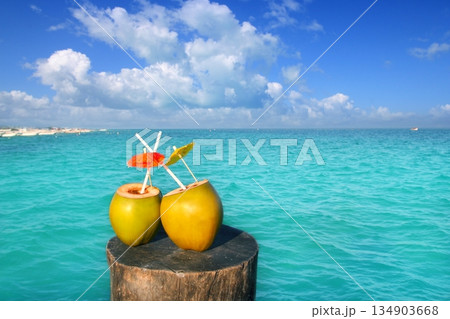 fresh two coconuts juice water straws in caribbean 134903668