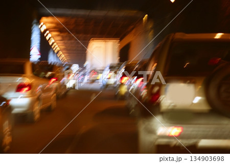 Cars moving traffic with brurred motion headlights on the tunnel 134903698