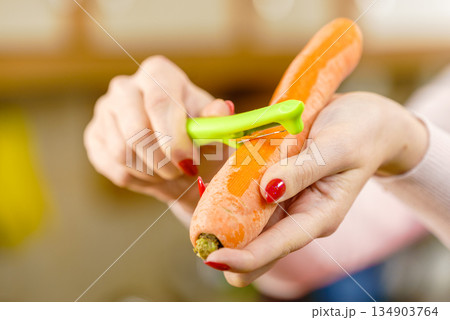 Woman peeling carrot vegetable Woman peeling carrot vegetable 134903764