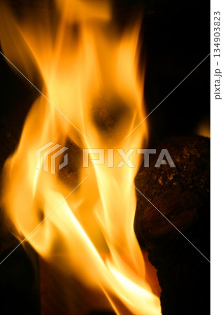 Orange fire over black background Orange fire over black background 134903823