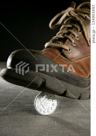euro currency coin tread by a boot euro currency coin tread by a boot 134903897