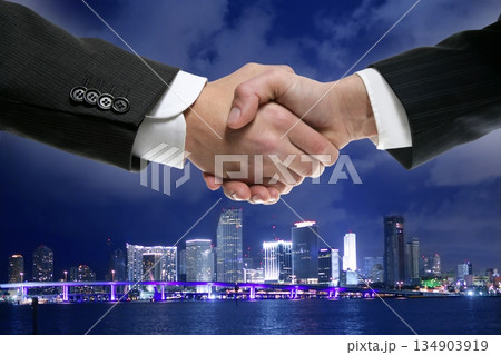 Businessman handshake in Miamy downtown night Businessman handshake in Miamy downtown night 134903919