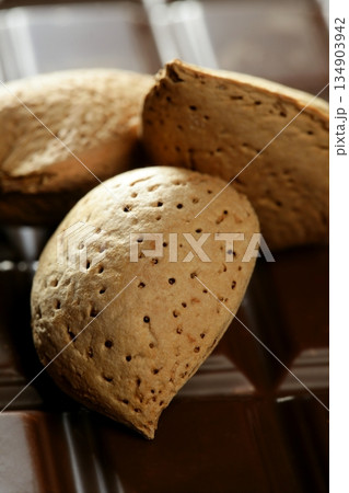 Almond nuts over chocolate, delicious golden food 134903942