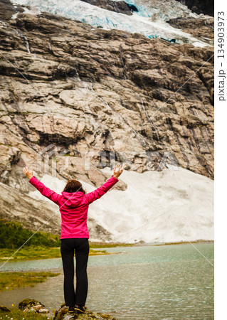 Tourist admiring Boyabreen Glacier in Norway 134903973