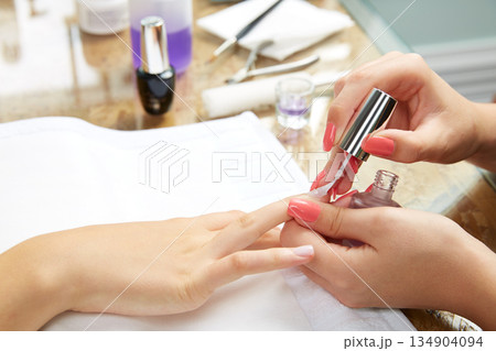 Nails painting woman with brush in Nail Salon Nails painting woman with brush in Nail Salon 134904094