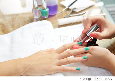 Nails painting woman with brush in Nail Salon Nails painting woman with brush in Nail Salon 134904095