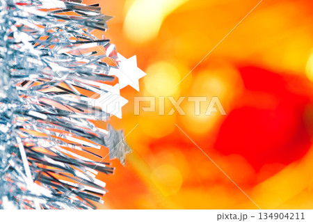 Christmas tinsel stars silver blue on red Christmas tinsel stars silver blue on red 134904211