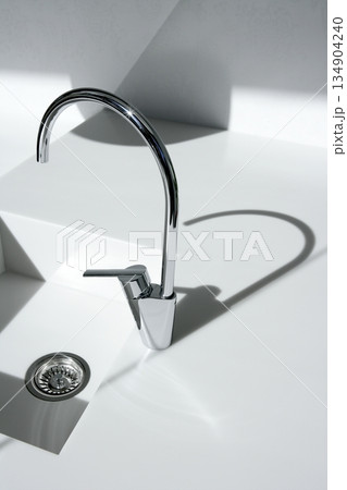 White modern kitchen detail, faucet and sink White modern kitchen detail, faucet and sink 134904240