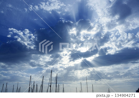 Cloudy sunset sky with sailboat mast 134904271