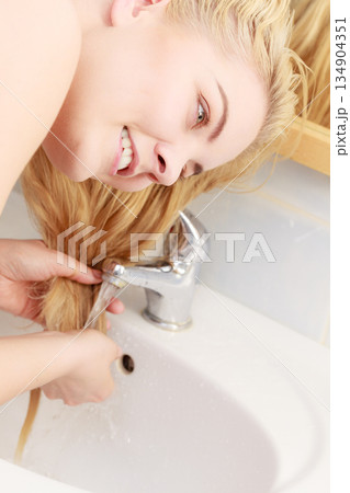Woman having wet blonde hair Woman having wet blonde hair 134904351
