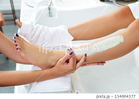 Aplying nourishing moisturizer mask woman legs 134904377