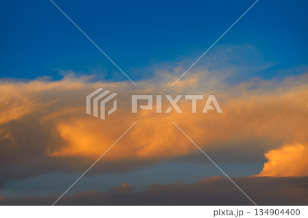 Sunset sky orange clouds on blue 134904400