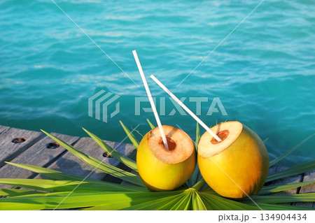 coconuts cocktail palm tree leaf in Caribbean coconuts cocktail palm tree leaf in Caribbean 134904434