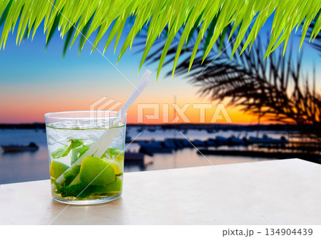 Cocktail Mojito in Balearic island sunset Cocktail Mojito in Balearic island sunset 134904439