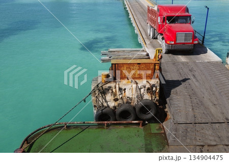 Caribbean gateway ferry with red truck coming aboard the boat 134904475