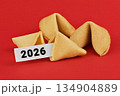 Traditional Chinese Fortune cookies on red background with paper slip showing 2026, concept of luck, prediction, new year 134904889