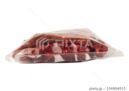 Roasted chilies in a plastic bag isolated on white background Roasted chilies in a plastic bag isolated on white background 134904915