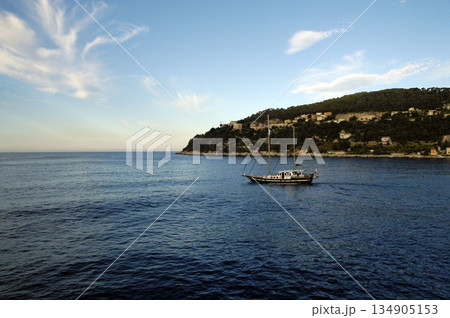 sailboat sailing along the coast on a sunny day sailboat sailing along the coast on a sunny day 134905153