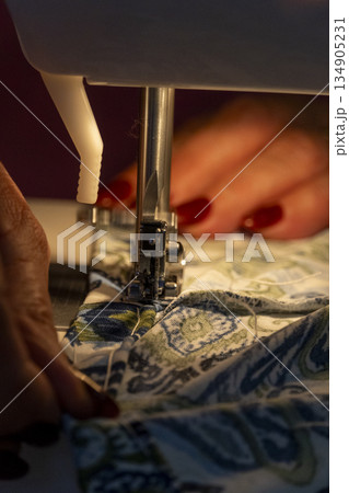 woman sewing by machine, close-up sewing tasks 134905231
