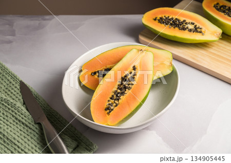 Papaya exotic fruit halves on plate. Healthy vegan food. 134905445