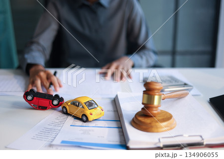Justice for car accidents with gavel and car model on the table concept for insurance claim, court hearing or personal injury lawsuit settlement. Justice for car accidents with gavel and car model on the table concept for insurance claim, court hearing or personal injury lawsuit settlement. 134906055