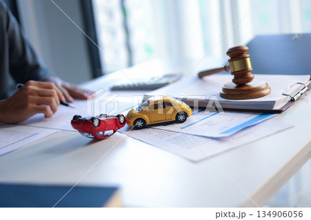 Justice for car accidents with gavel and car model on the table concept for insurance claim, court hearing or personal injury lawsuit settlement. 134906056