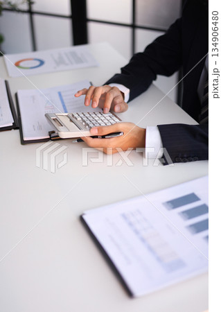 Businessman working in office calculating tax. Businessman working in office calculating tax. 134906480