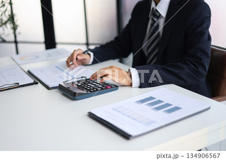 Businessman working in office calculating tax. Businessman working in office calculating tax. 134906567