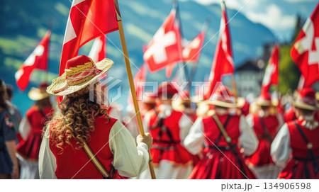 Swiss National Day street festival with a crowd in national costumes waving flags. A vibrant celebration of Swiss heritage, ideal for tourism promotions or cultural event coverage 134906598