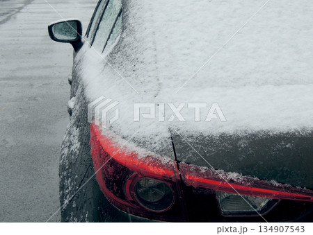 Snow cover the rear lights of the car on the frozen road Snow cover the rear lights of the car on the frozen road 134907543
