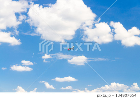 Airplane take off into a blue sky with white clouds, Passenger plane aircraft flying on blue sky background Airplane take off into a blue sky with white clouds, Passenger plane aircraft flying on blue sky background 134907654
