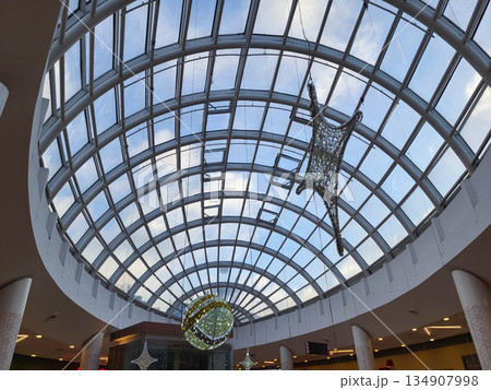Oval ceiling with a Christmas star and a New Year's ball in a supermarket Oval ceiling with a Christmas star and a New Year's ball in a supermarket 134907998