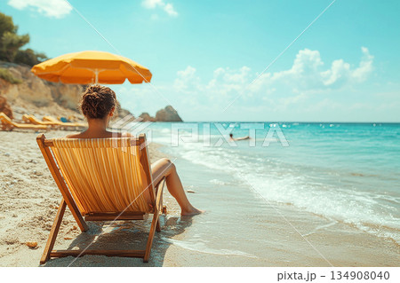 Summer sky and clouds. Sunny. Umbrella and chairs set up on sand in beach of ocean. Summer sky and clouds. Sunny. Umbrella and chairs set up on sand in beach of ocean. 134908040