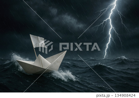 A paper ship sails in a stormy ocean. 134908424